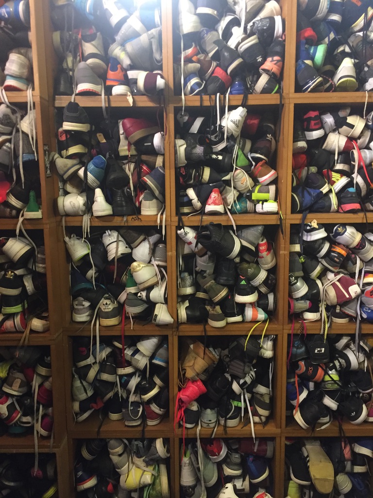 A wall of well-worn sneakers